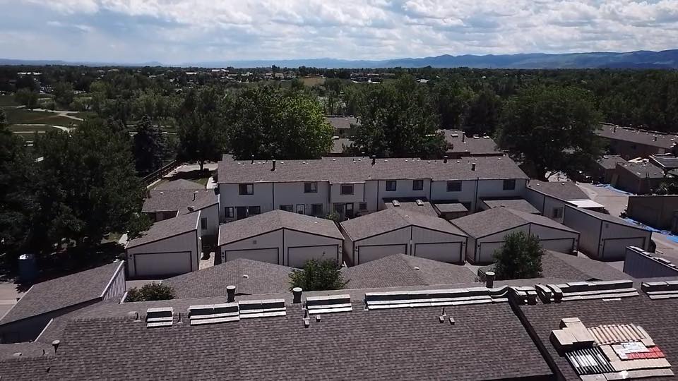 large multifamily project with condos and detached garages many asphalt roofs on a large multifamily complex including condos and detached garages