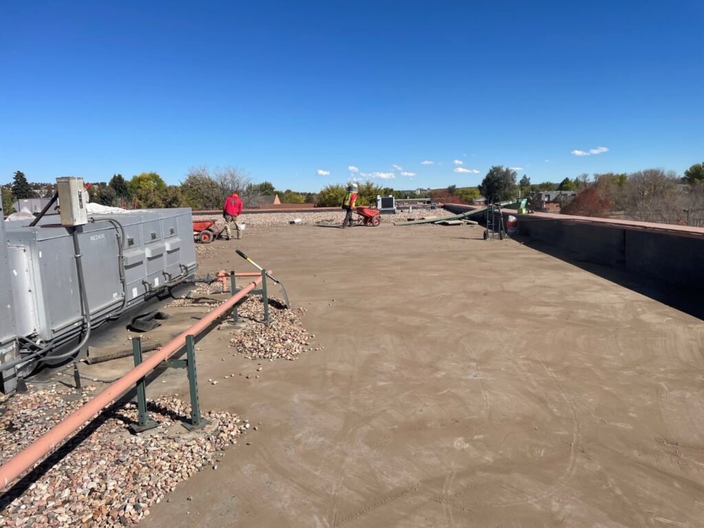 Ballast removal process during Mullen High School commercial roofing project