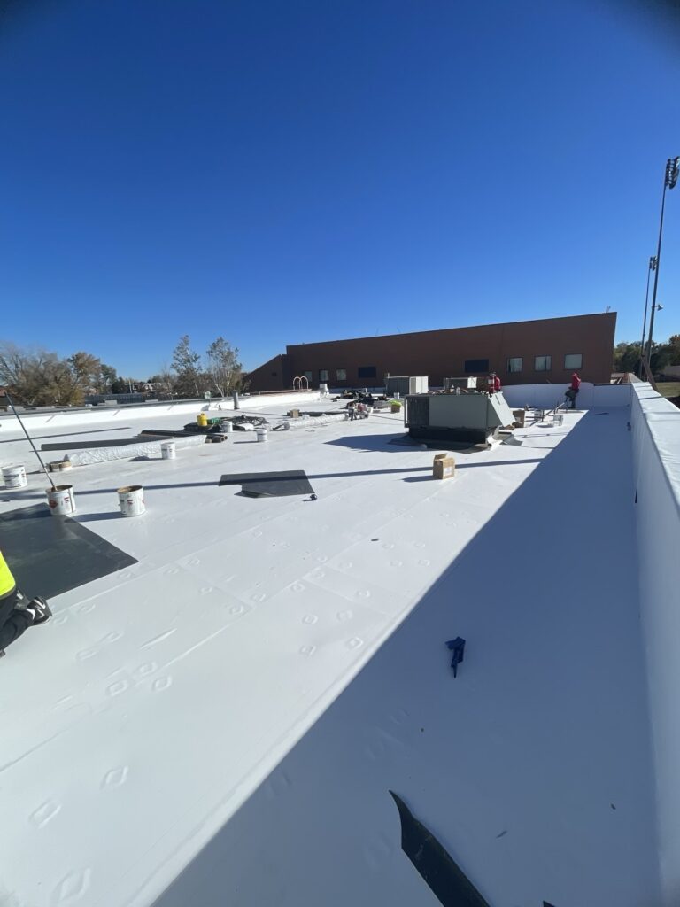 TPO roofing material installation on Mullen High School building in Denver